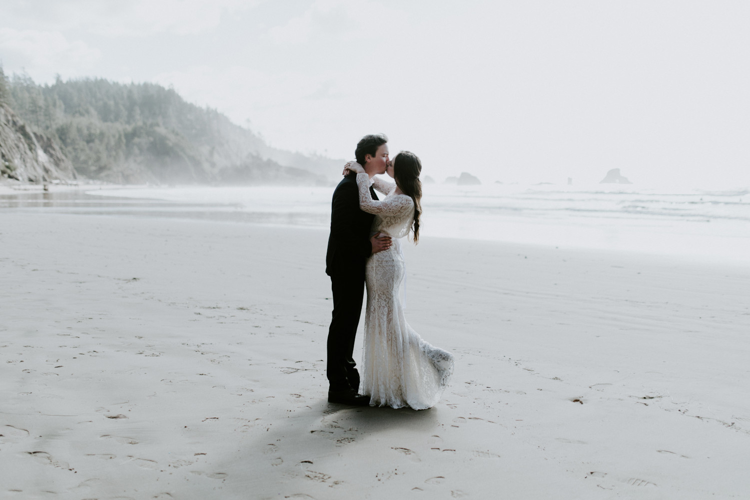 Nicole and Vlad hold each other at Indian Beach. Elopement wedding photography at Cannon Beach by Sienna Plus Josh.