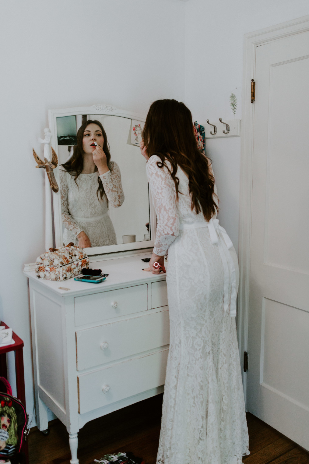 Nicole puts on lipstick at Cannon Beach. Elopement wedding photography at Cannon Beach by Sienna Plus Josh.