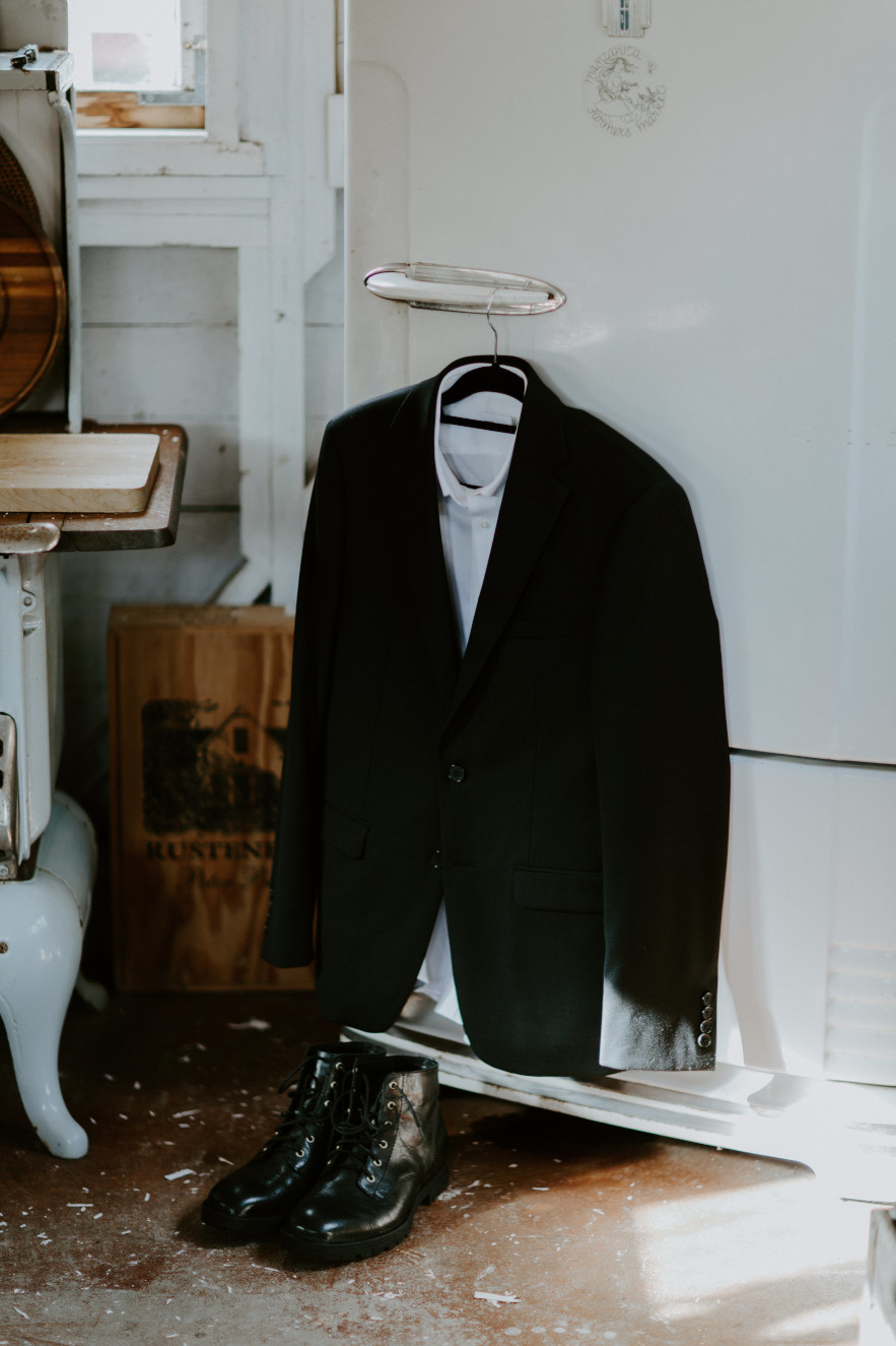 Vlad's jacket hangs on an antique fridge. Elopement wedding photography at Cannon Beach by Sienna Plus Josh.