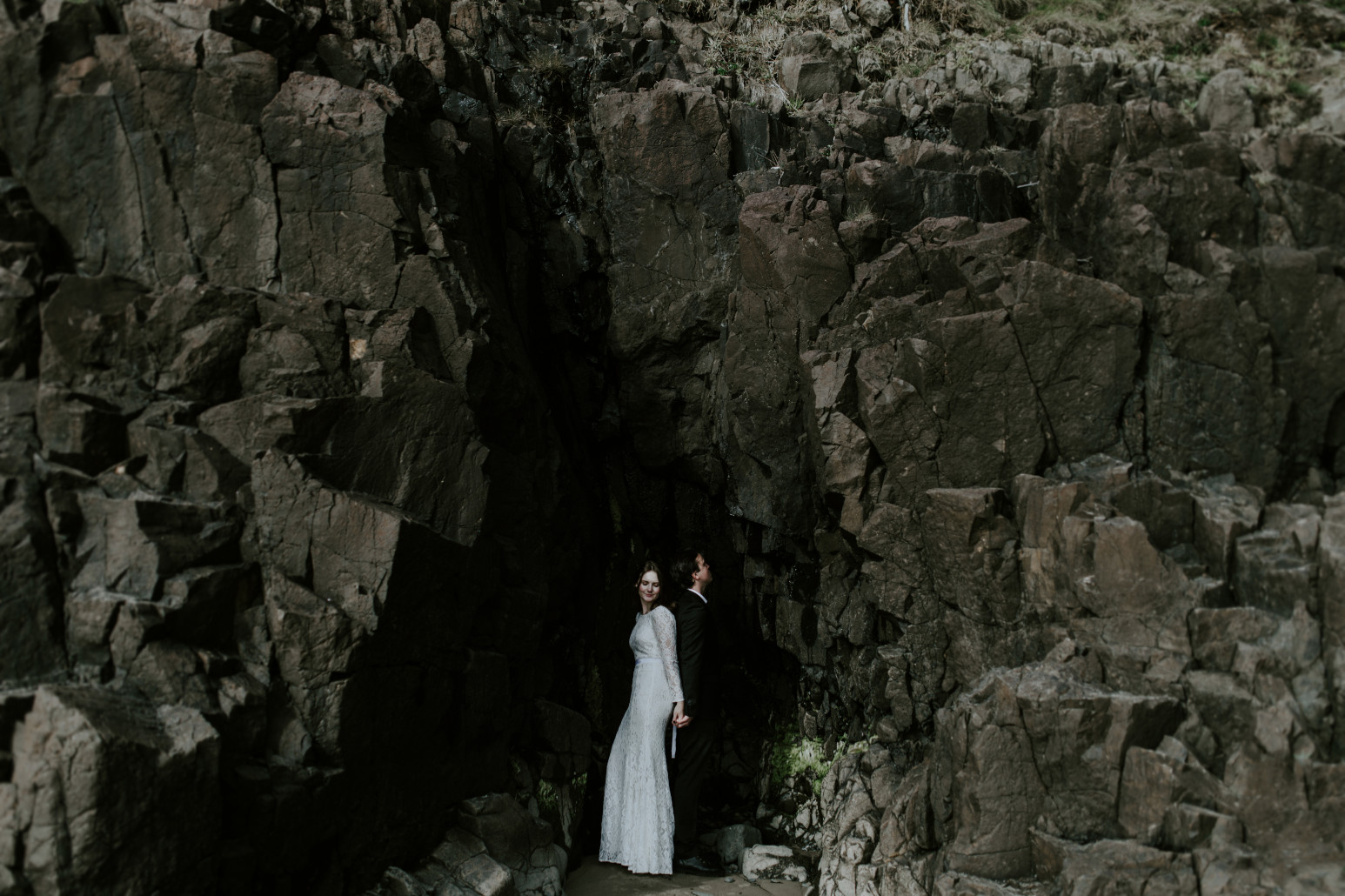 Nicole and Vlad stand in front of the rocks at Indian Beach. Elopement wedding photography at Cannon Beach by Sienna Plus Josh.