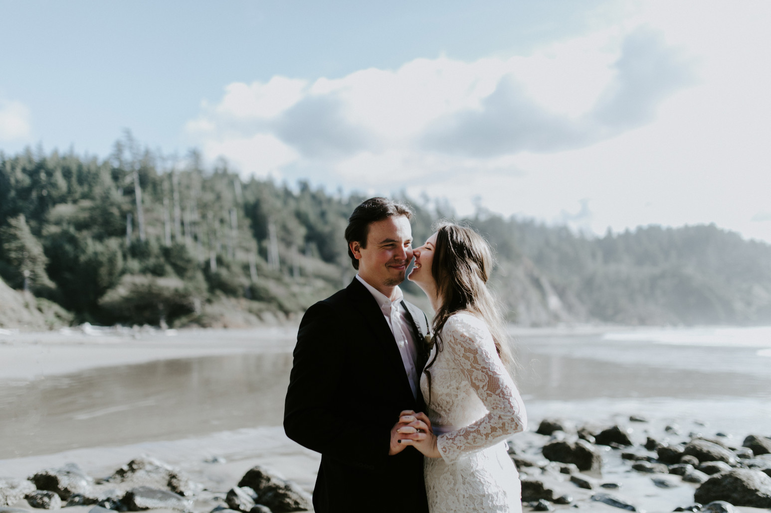 Nicole and Vlad standing on the sand. Elopement wedding photography at Cannon Beach by Sienna Plus Josh.