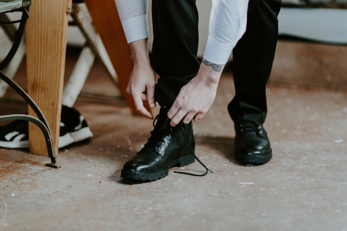 Vlad ties his shoes. Elopement wedding photography at Cannon Beach by Sienna Plus Josh.