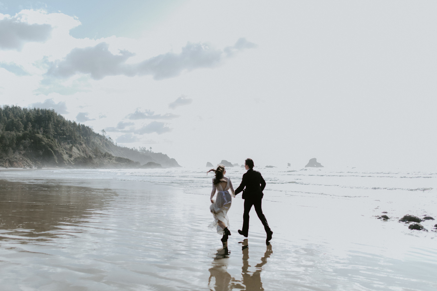 Nicole and Vlad run on Indian Beach. Elopement wedding photography at Cannon Beach by Sienna Plus Josh.