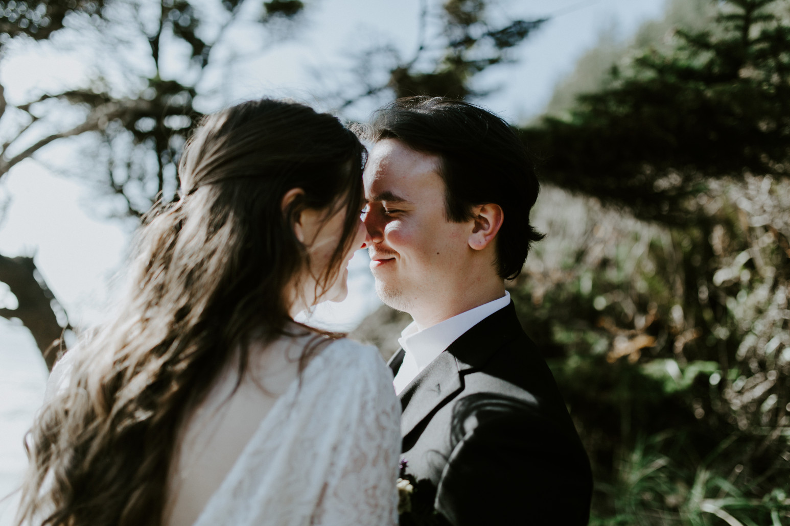 Nicole and Vlad smile at each other. Elopement wedding photography at Cannon Beach by Sienna Plus Josh.