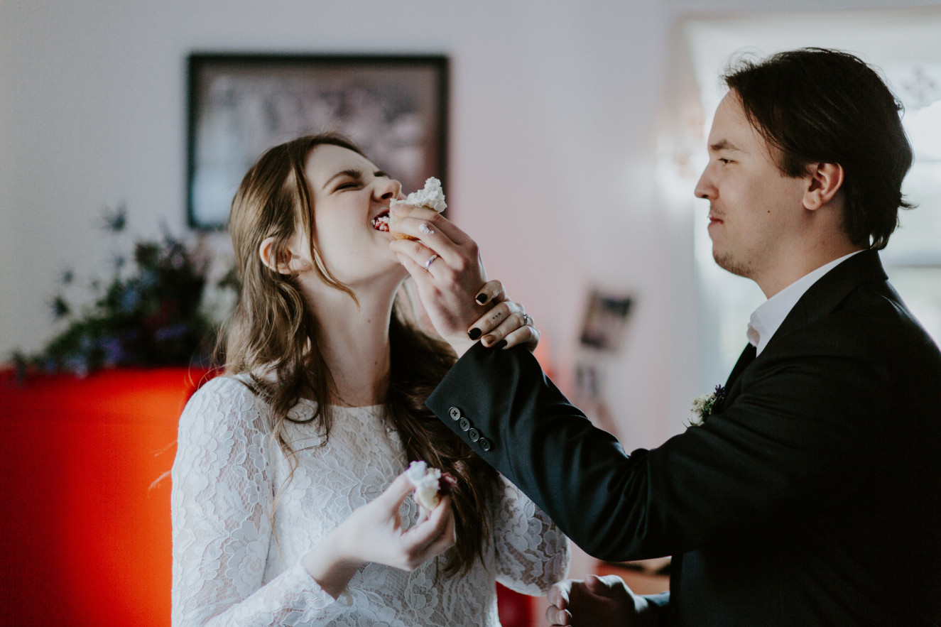 Vlad feeds Nicole some of his cupcake. Elopement wedding photography at Cannon Beach by Sienna Plus Josh.