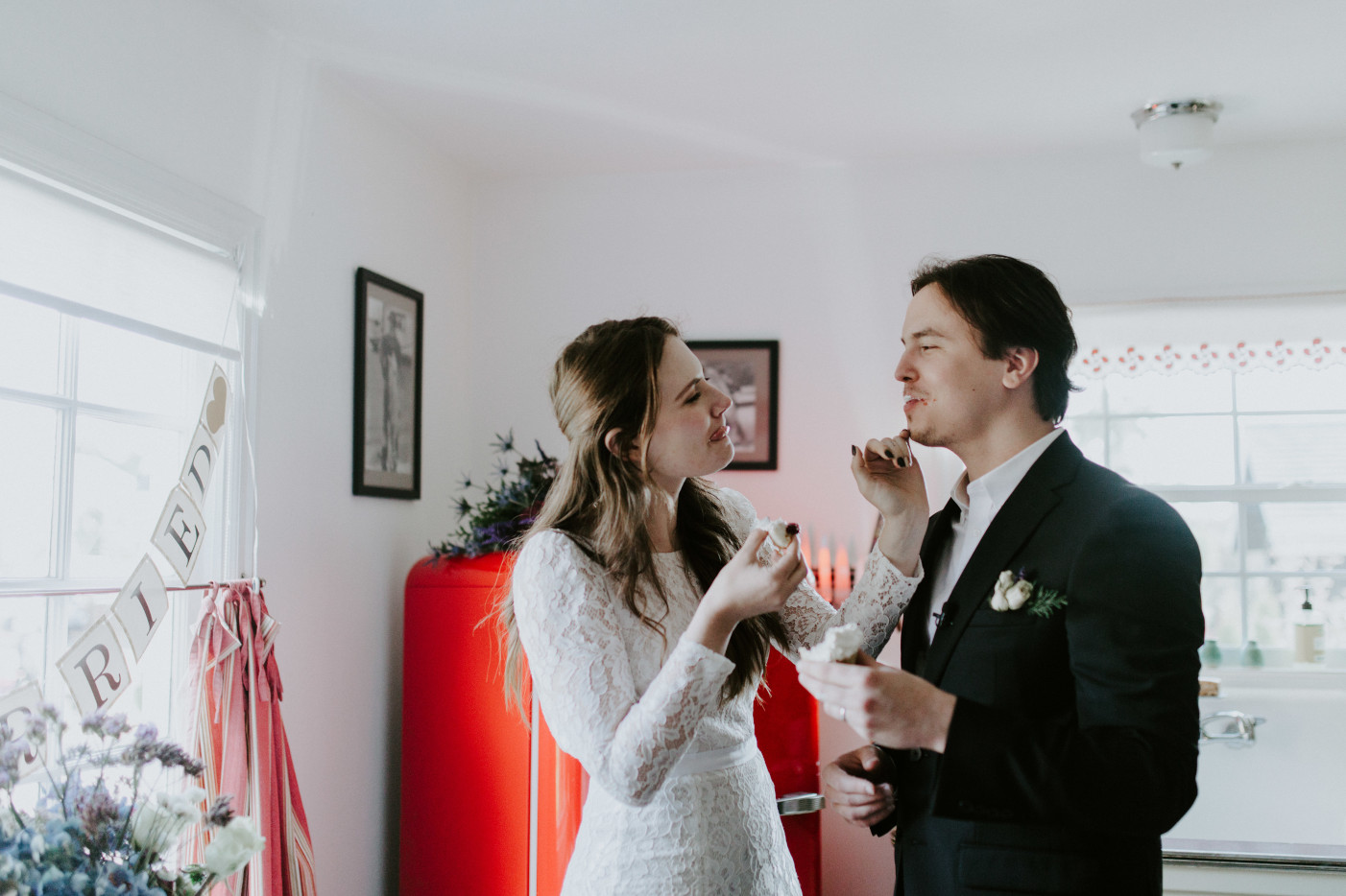 Nicole and Vlad have fun with their cake. Elopement wedding photography at Cannon Beach by Sienna Plus Josh.