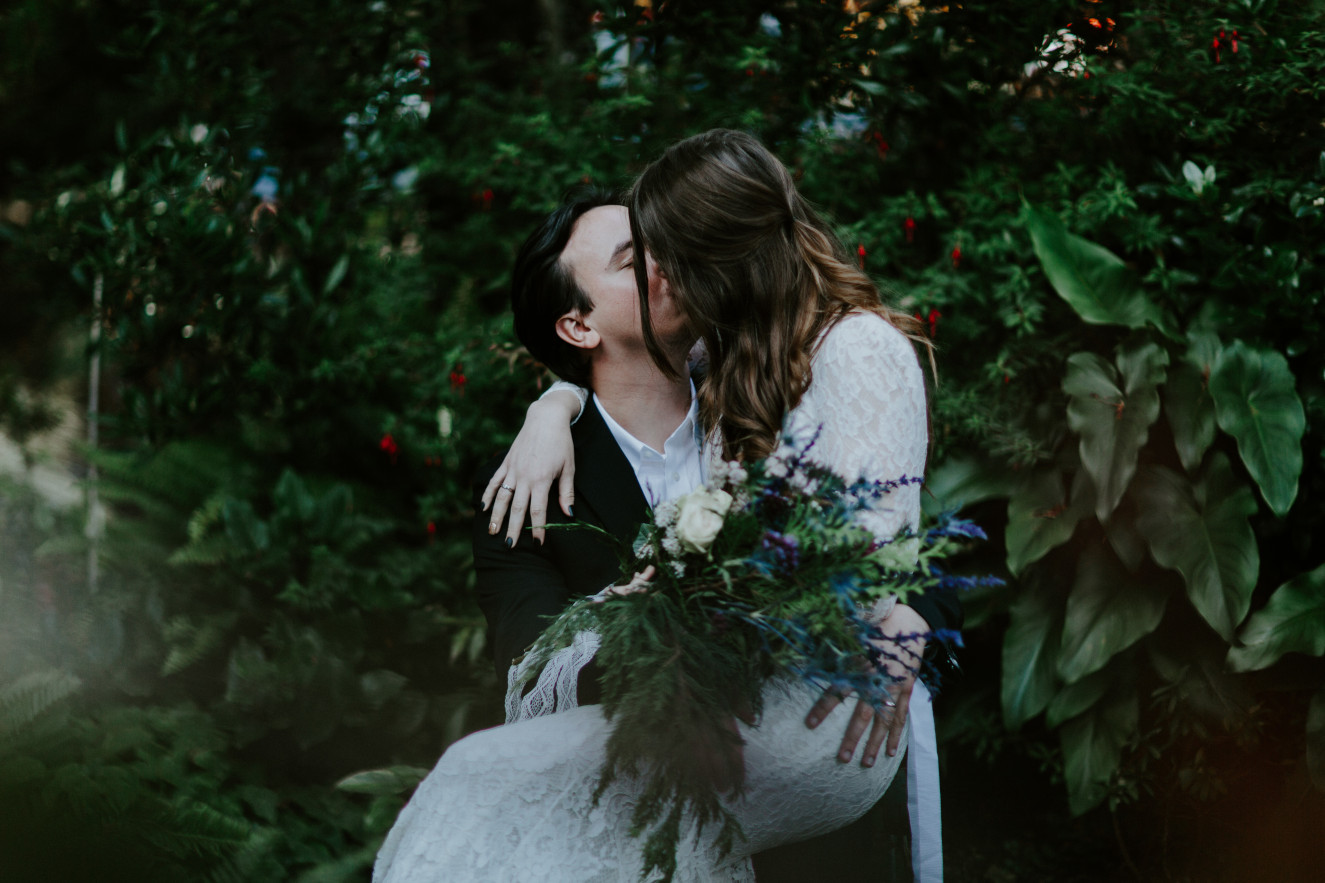 Nicole and Vlad sit in the garden of their AirBnB. Elopement wedding photography at Cannon Beach by Sienna Plus Josh.