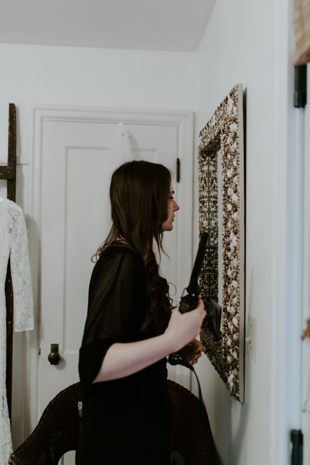 Nicole does her hair in a mirro. Elopement wedding photography at Cannon Beach by Sienna Plus Josh.