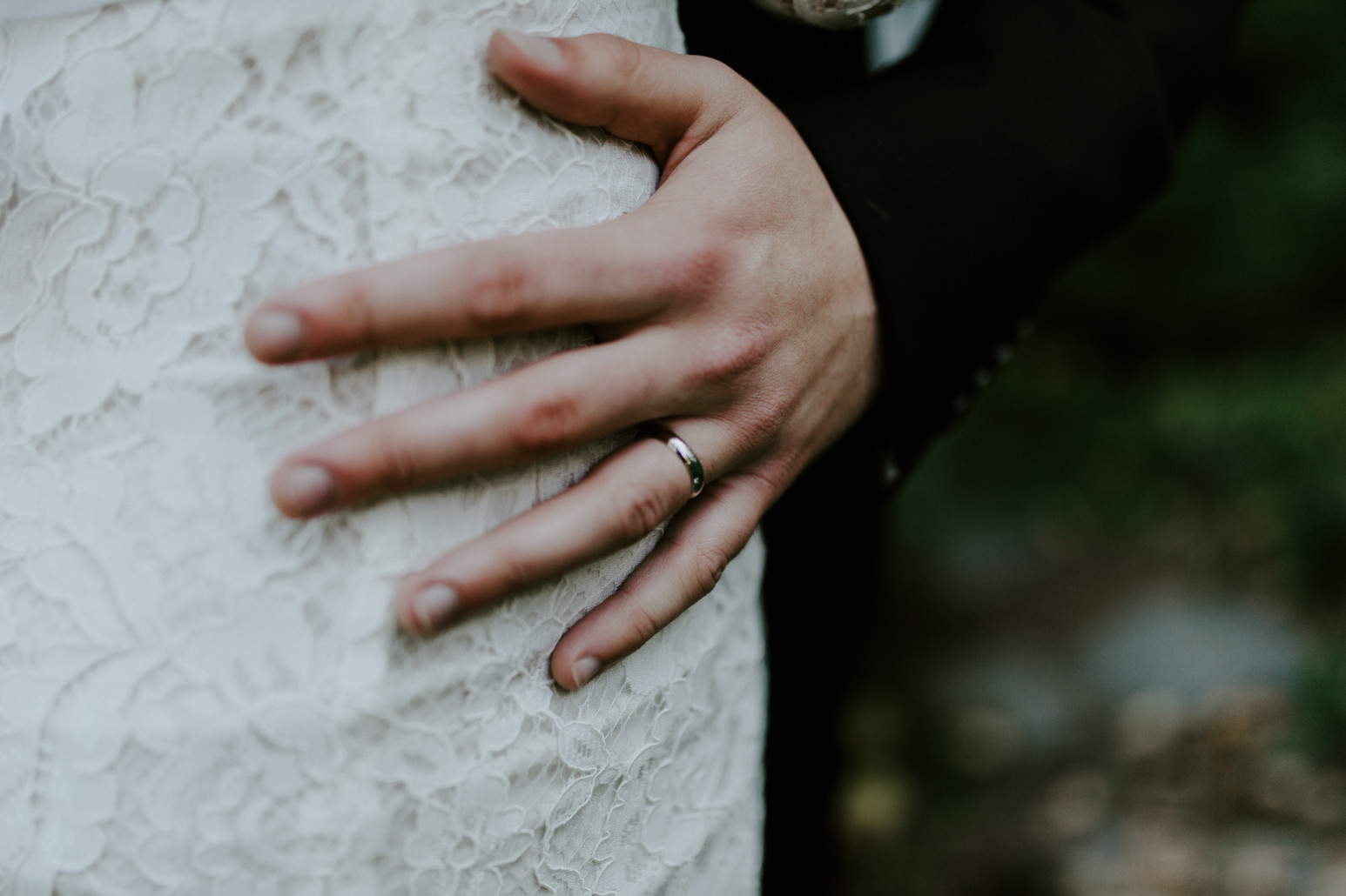 Vlad's hand on Nicole's dress. Elopement wedding photography at Cannon Beach by Sienna Plus Josh.