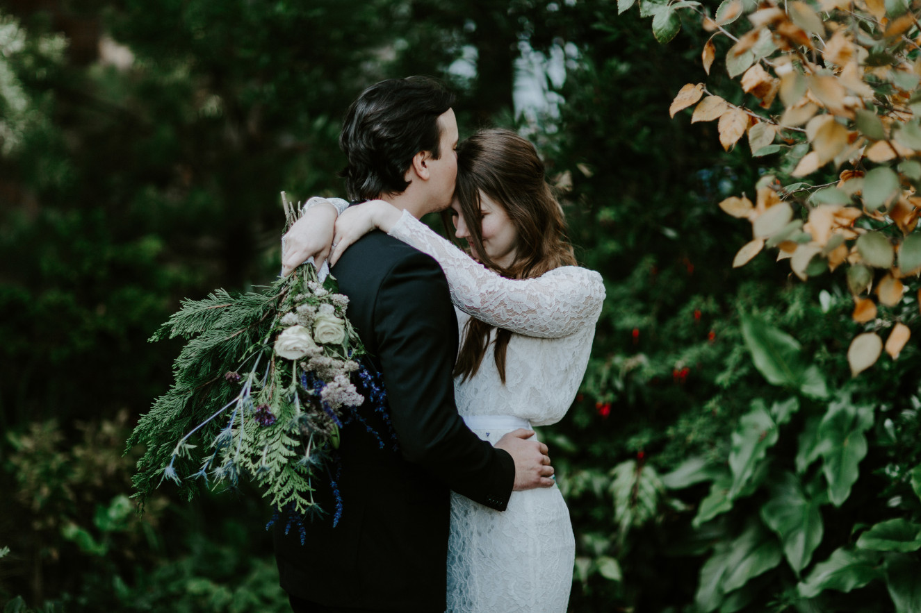 Vlad kisses Nicole's forehead. Elopement wedding photography at Cannon Beach by Sienna Plus Josh.