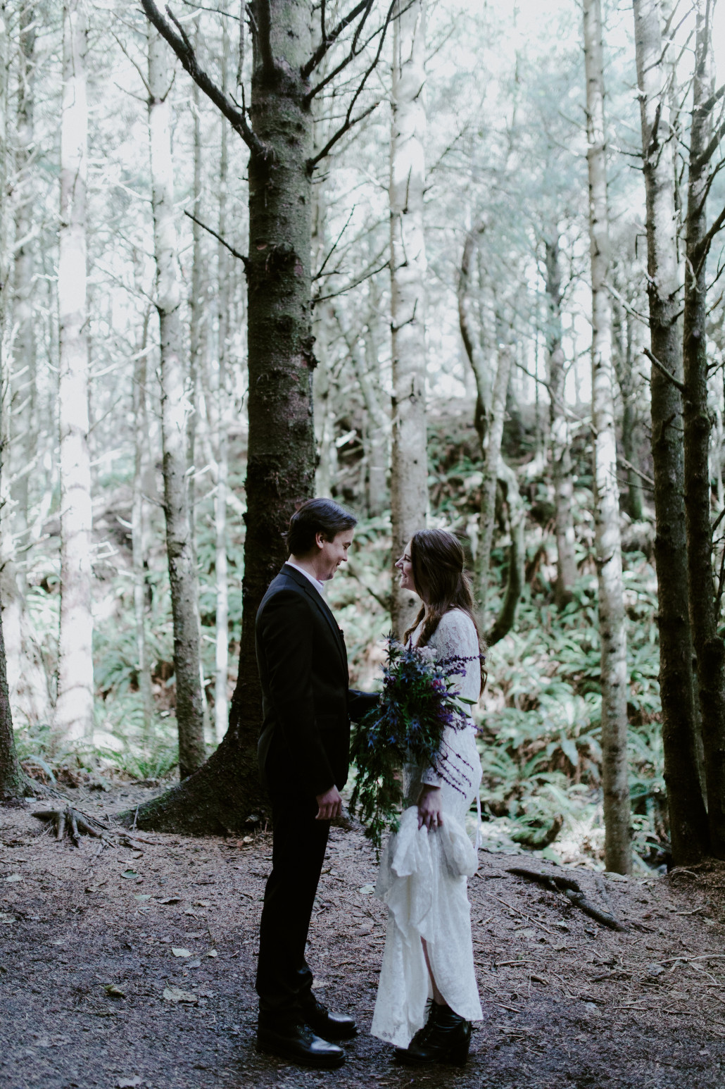 Vlad and Nicole stand in front of each other Cannon Beach, OR. Elopement wedding photography at Cannon Beach by Sienna Plus Josh.