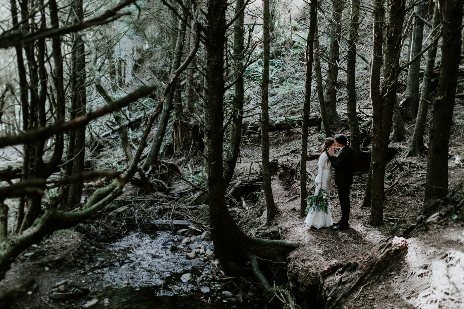 Nicole and Vlad stand in the woods at Cannon Beach, OR. Elopement wedding photography at Cannon Beach by Sienna Plus Josh.
