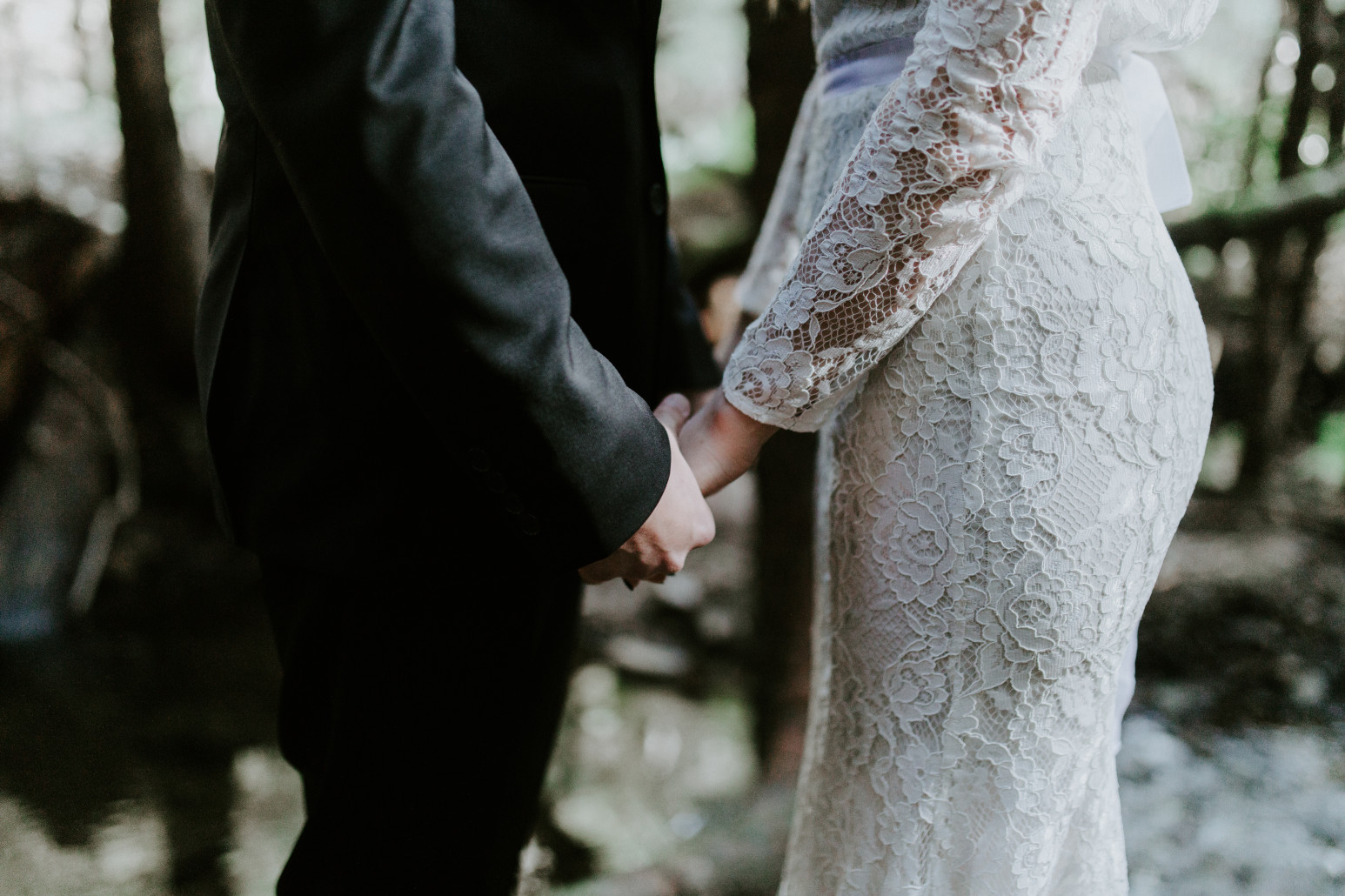 Vlad and Nicole hold hands. Elopement wedding photography at Cannon Beach by Sienna Plus Josh.