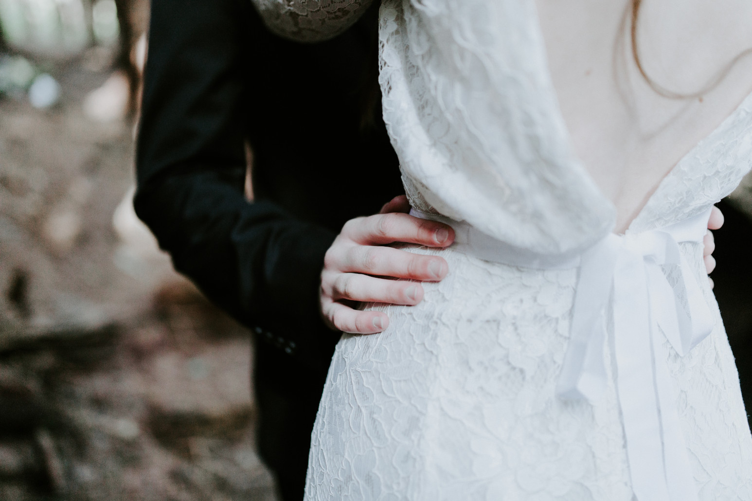 Vlad's hand on Nicole's waist at Cannon Beach. Elopement wedding photography at Cannon Beach by Sienna Plus Josh.