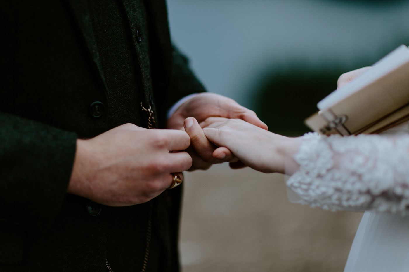 Alex holds Elizabeth's hand to exchange rings. Elopement photography at North Cascades National Park by Sienna Plus Josh.