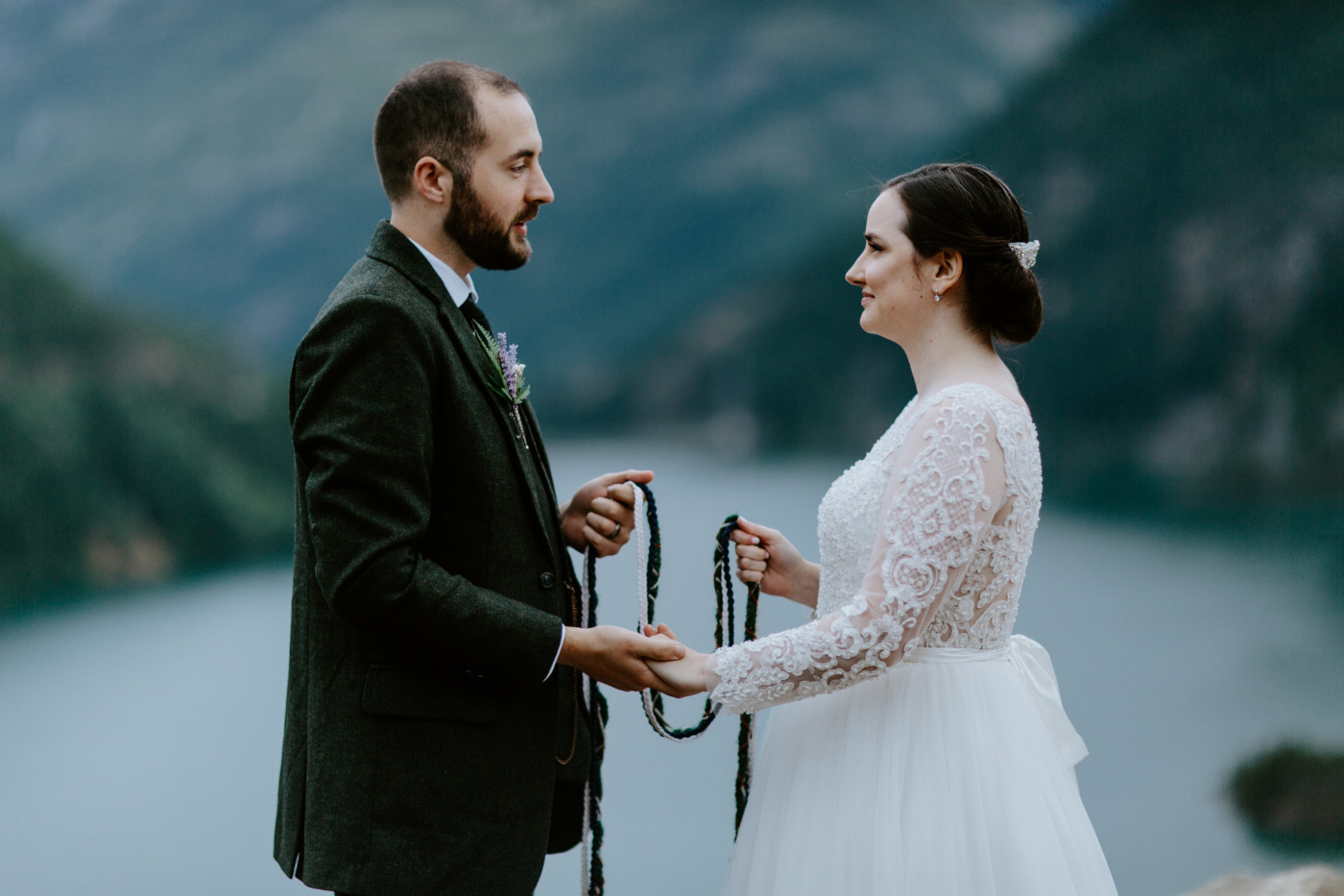 Alex and Elizabeth's begin the hand tying ceremony. Elopement photography at North Cascades National Park by Sienna Plus Josh.