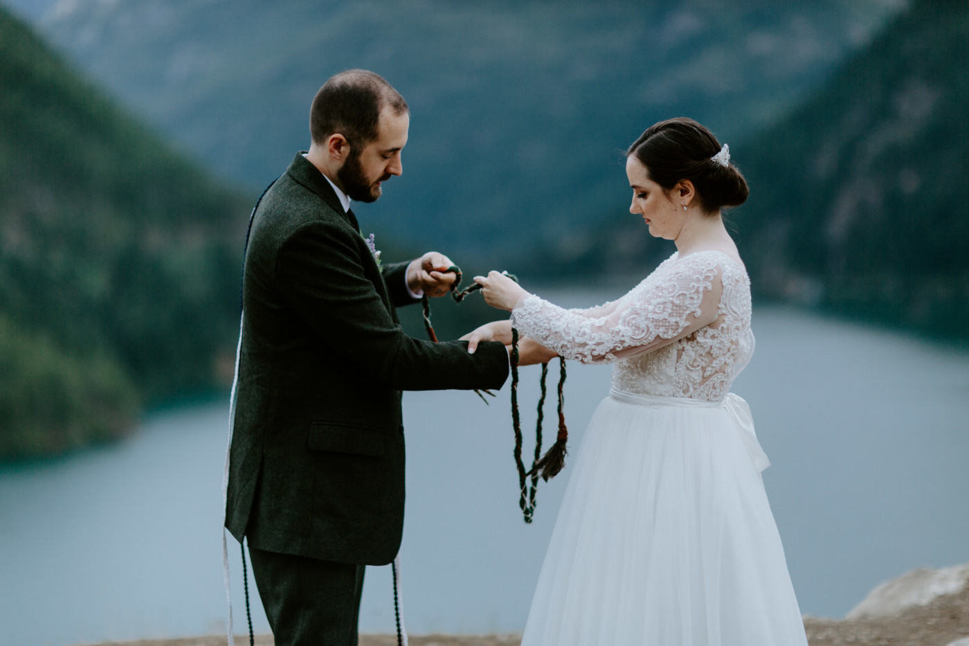 Elizabeth and Alex drape the rope over their hands. Elopement photography at North Cascades National Park by Sienna Plus Josh.