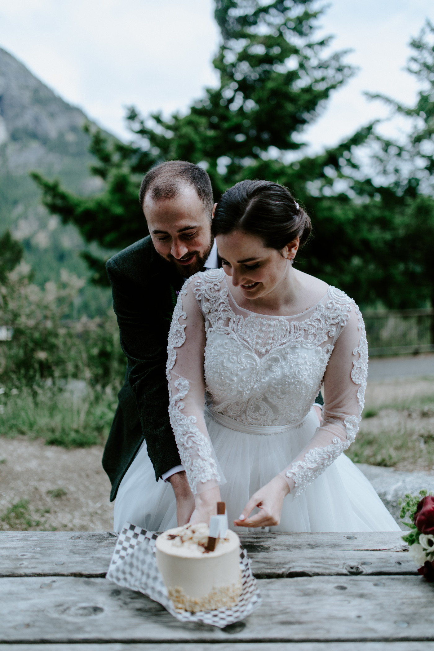 Elizabeth and Alex cut their wedding cake. Elopement photography at North Cascades National Park by Sienna Plus Josh.