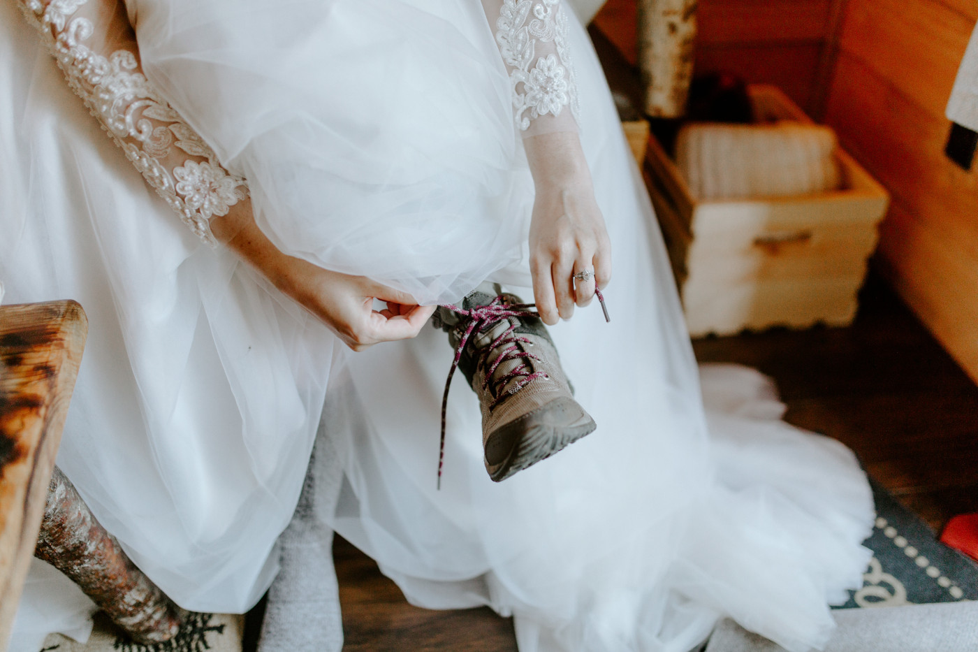 Elizabeth puts on her hiking boots. Elopement photography at North Cascades National Park by Sienna Plus Josh.