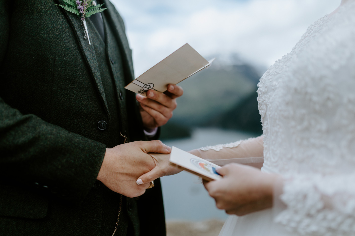 Alex and Elizabeth hold hands during their elopement ceremony. Elopement photography at North Cascades National Park by Sienna Plus Josh.