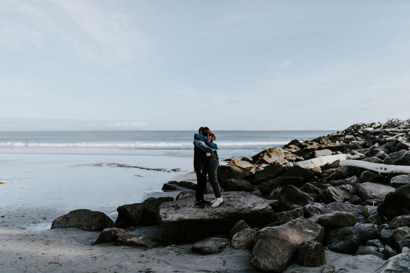 Taylor and Kyle hug near the ocean. Elopement photography at North Cascades National Park by Sienna Plus Josh.