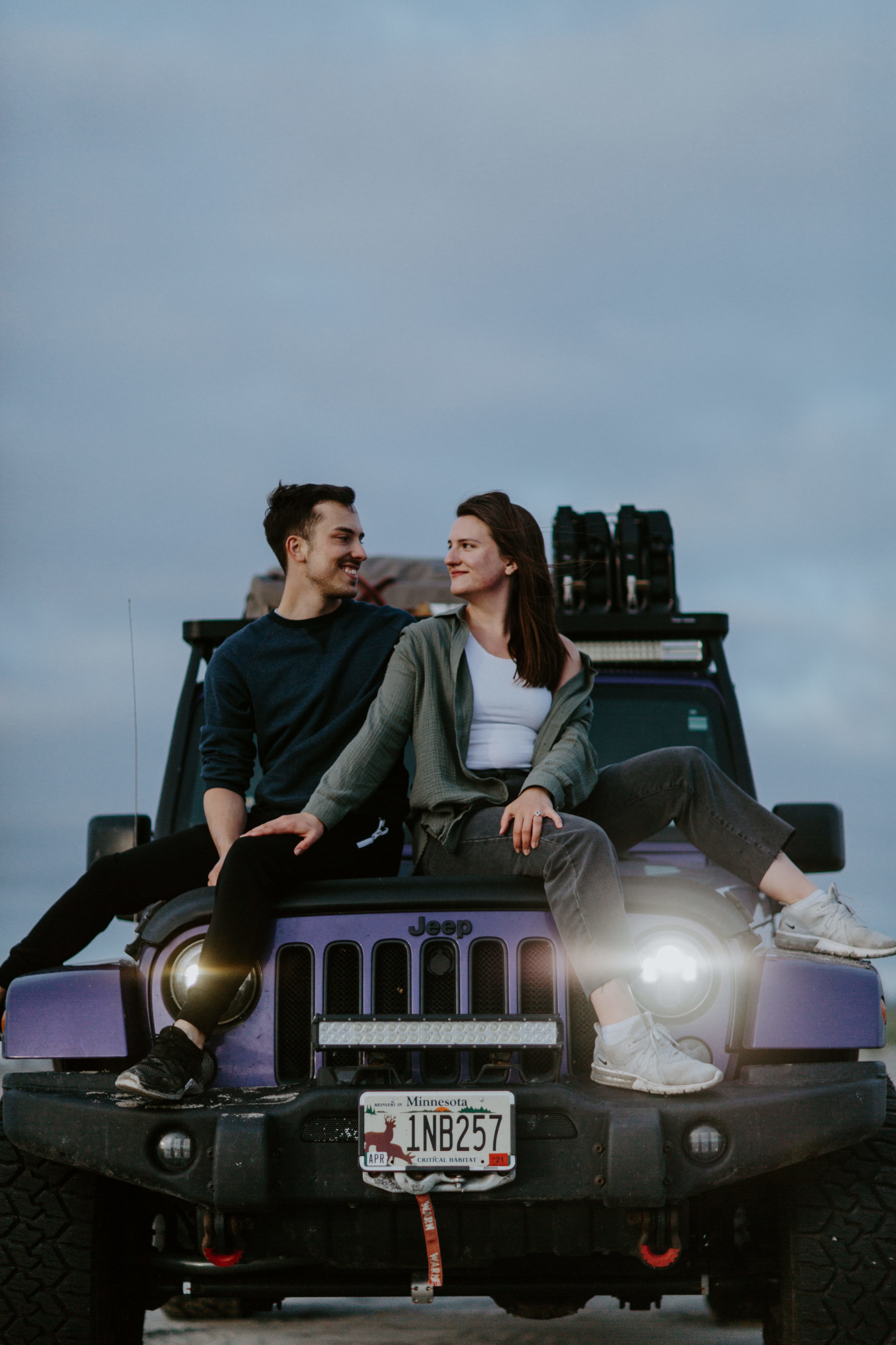 Taylor and Kyle sit on the hood of the Jeep. Elopement photography at North Cascades National Park by Sienna Plus Josh.