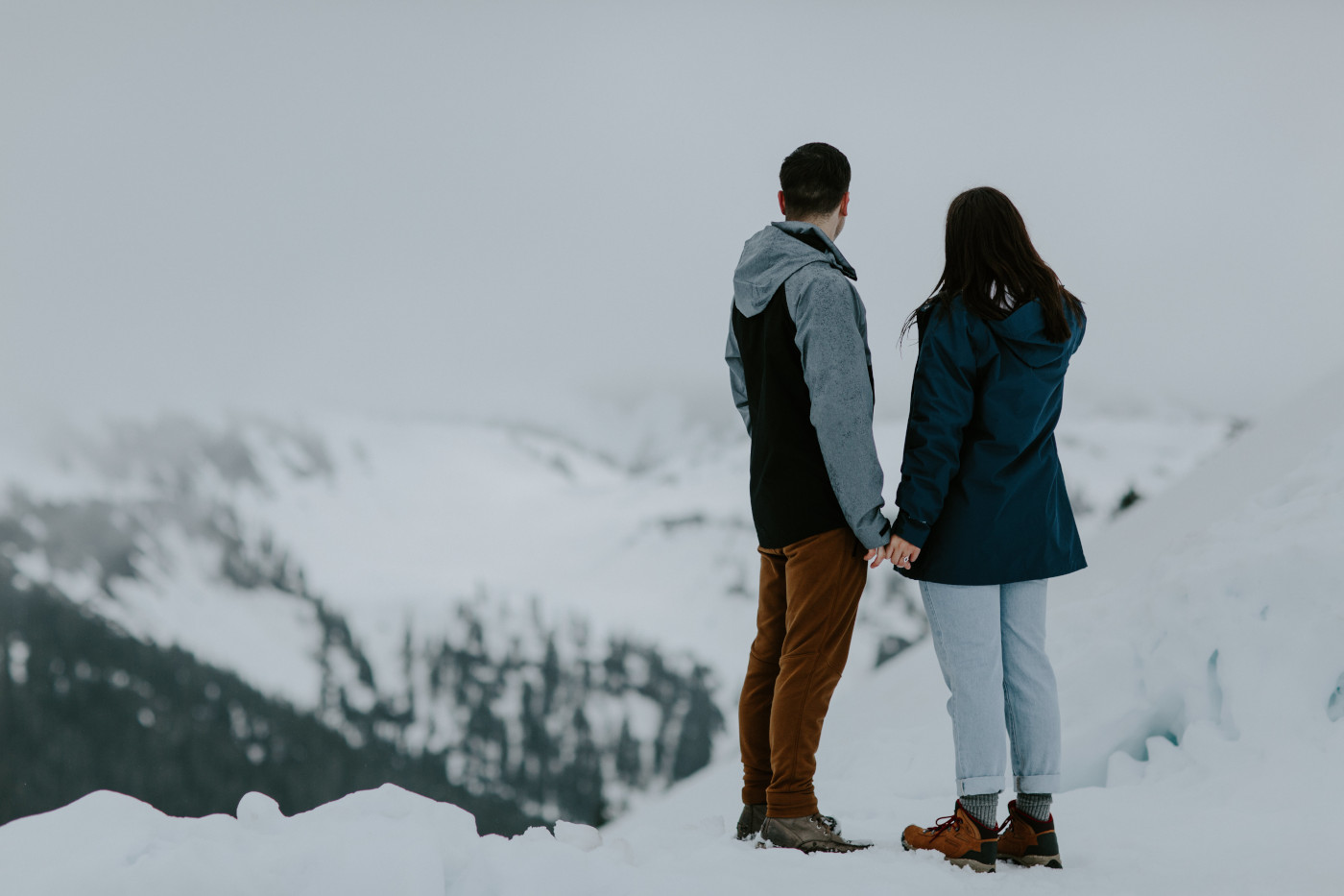 Taylor and Kyle admire the expansive view from the top of a mountain. Elopement photography at North Cascades National Park by Sienna Plus Josh.