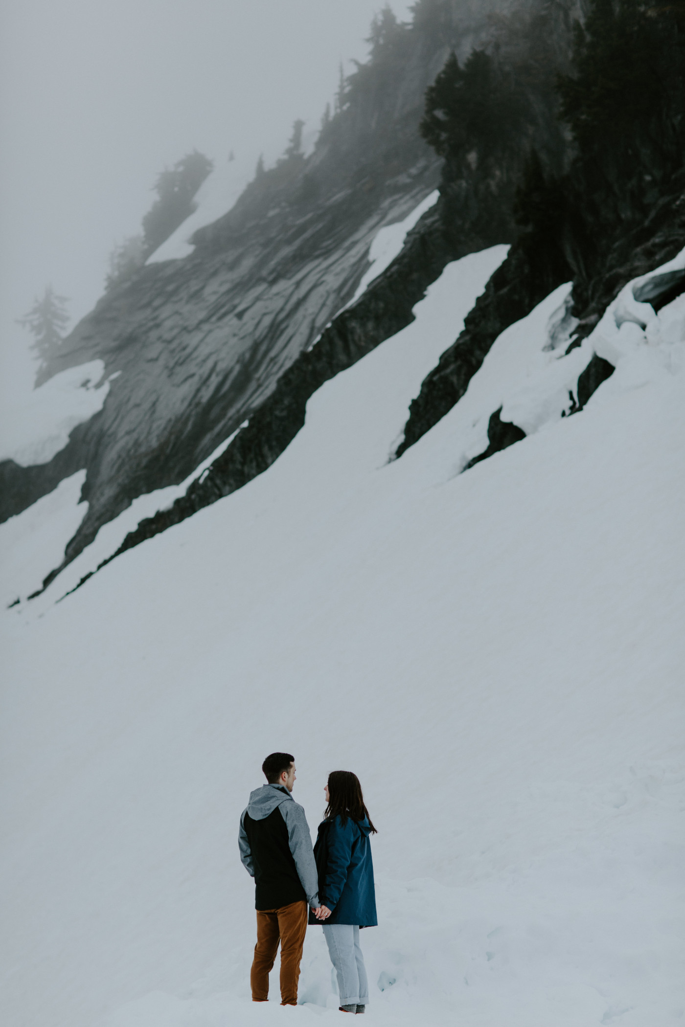Kyle and Taylor stand next to the side of the mountain. Elopement photography at North Cascades National Park by Sienna Plus Josh.