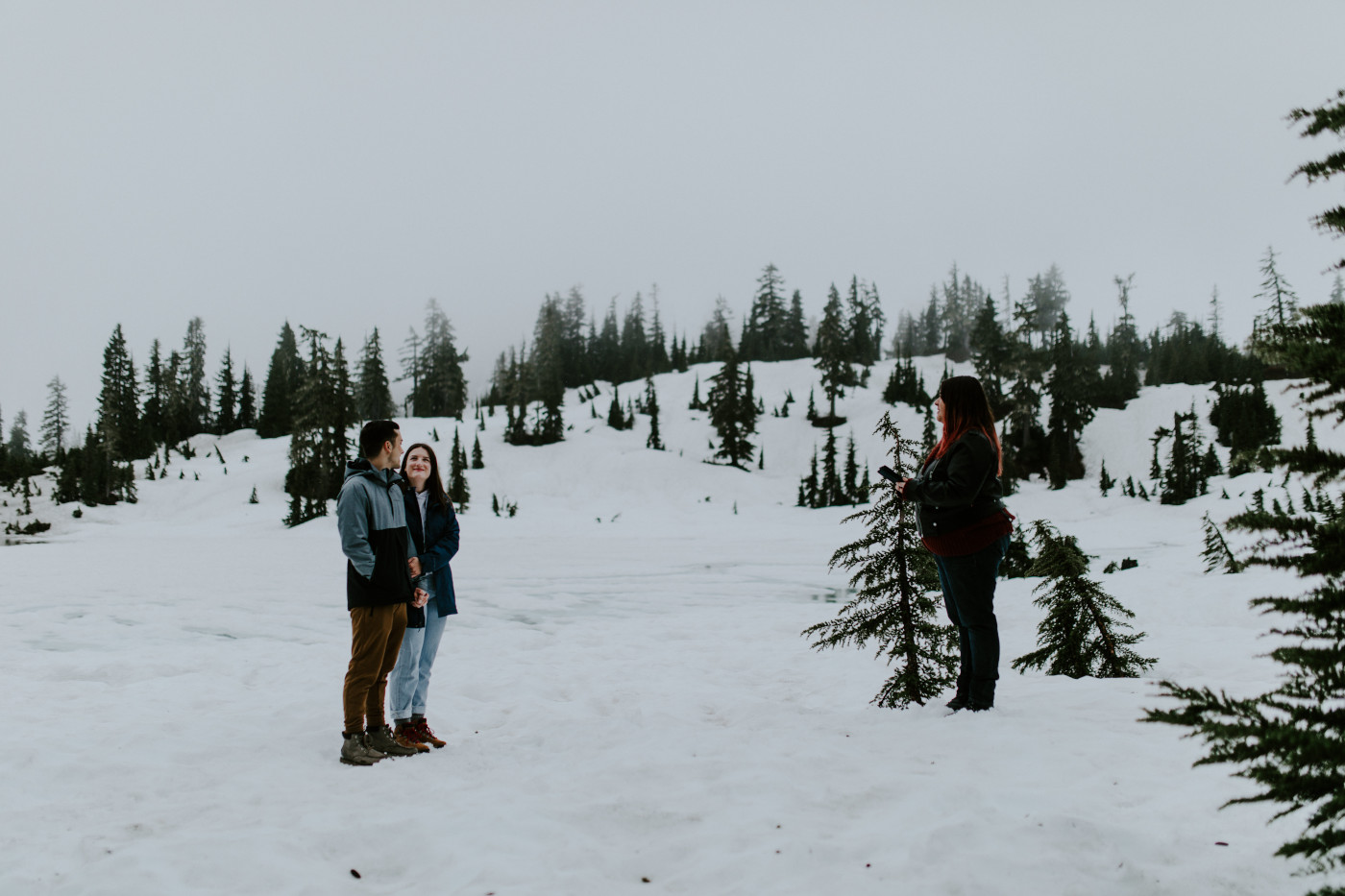 Taylor and Kyle stand side by side while Marie, their officiant, performs their elopement ceremony. Elopement photography at North Cascades National Park by Sienna Plus Josh.