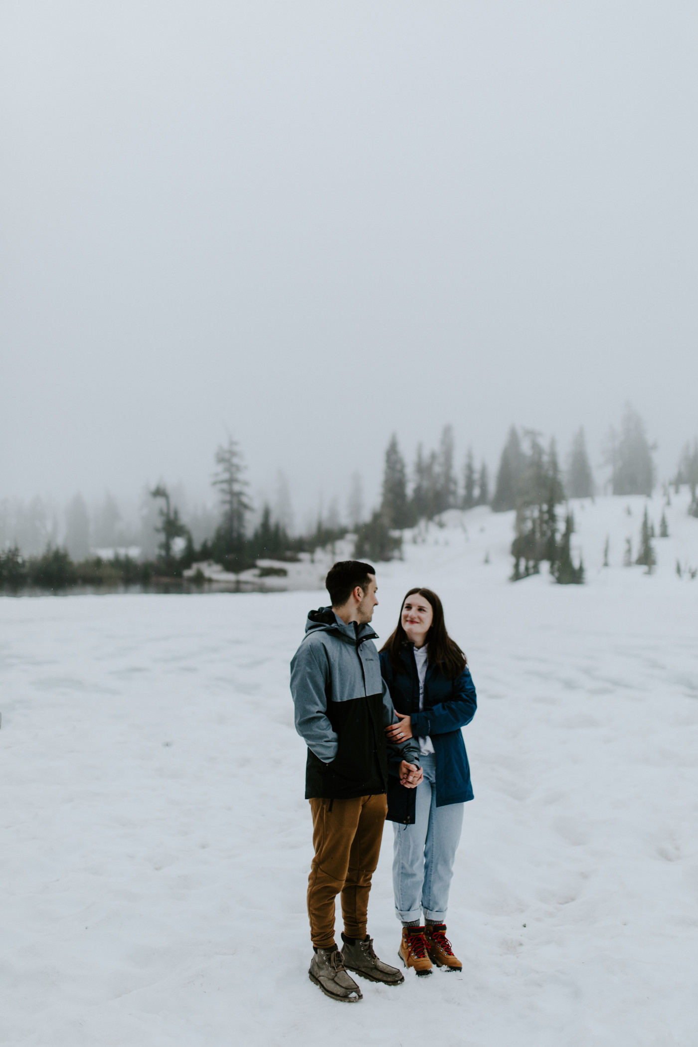 Kyle and Taylor standig in the snow. Elopement photography at North Cascades National Park by Sienna Plus Josh.