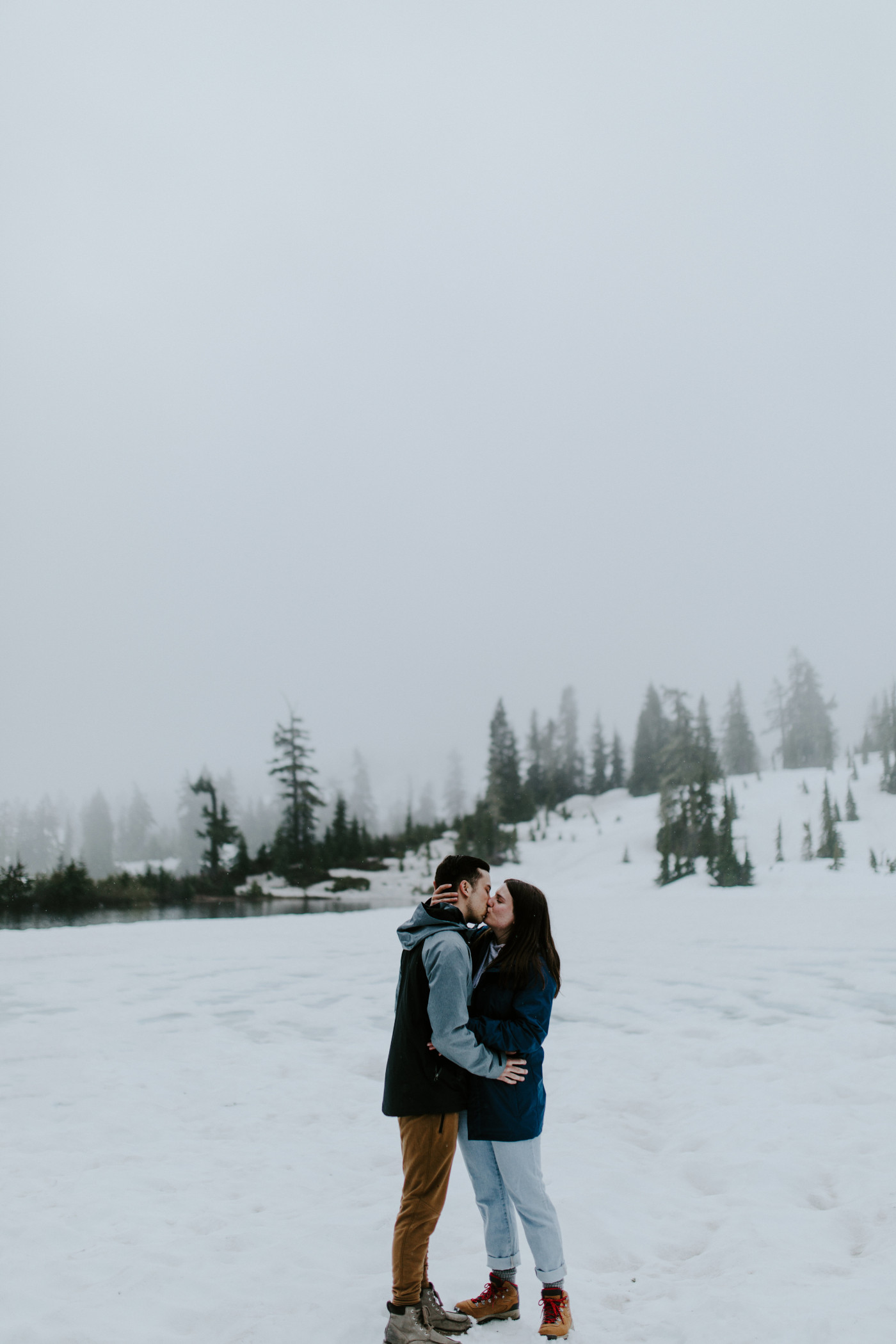 Kyle and Taylor kiss in the snow. Elopement photography at North Cascades National Park by Sienna Plus Josh.