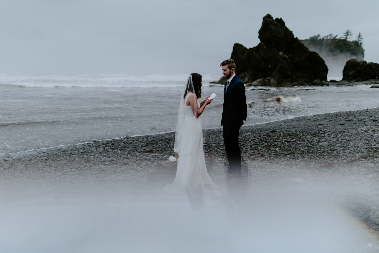 Corey and Mollie stand on the beach and read their vows. Elopement photography in the Olympic National Park by Sienna Plus Josh.