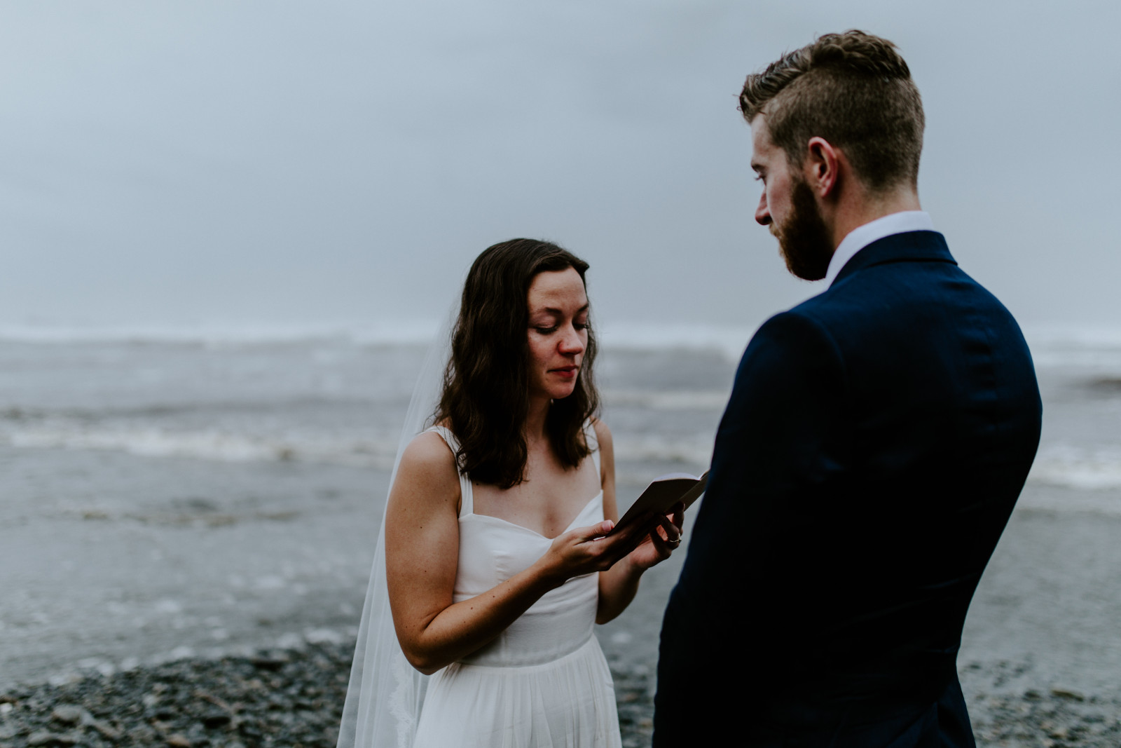 Mollie and Corey share a moment as they read vows. Elopement photography in the Olympic National Park by Sienna Plus Josh.