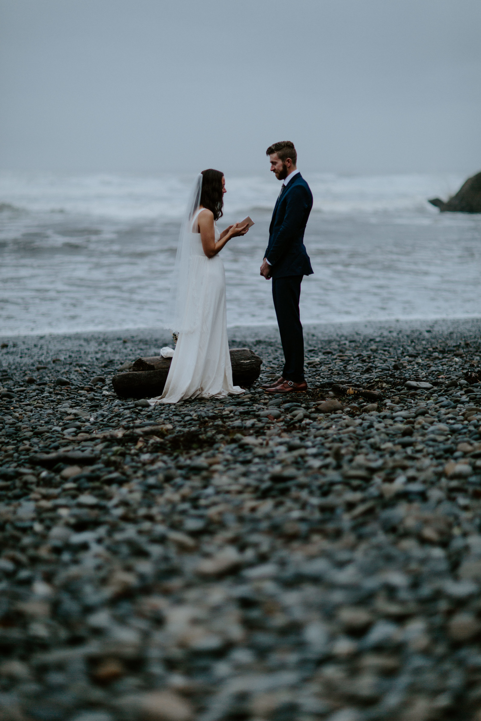 Corey and Mollie stand together on the beach during their elopement ceremony. Elopement photography in the Olympic National Park by Sienna Plus Josh.
