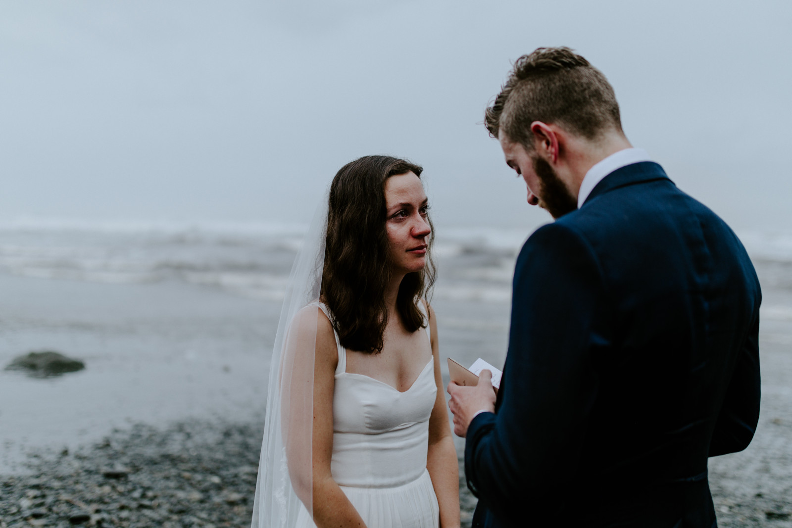 Mollie listens to Corey read his vows. Elopement photography in the Olympic National Park by Sienna Plus Josh.