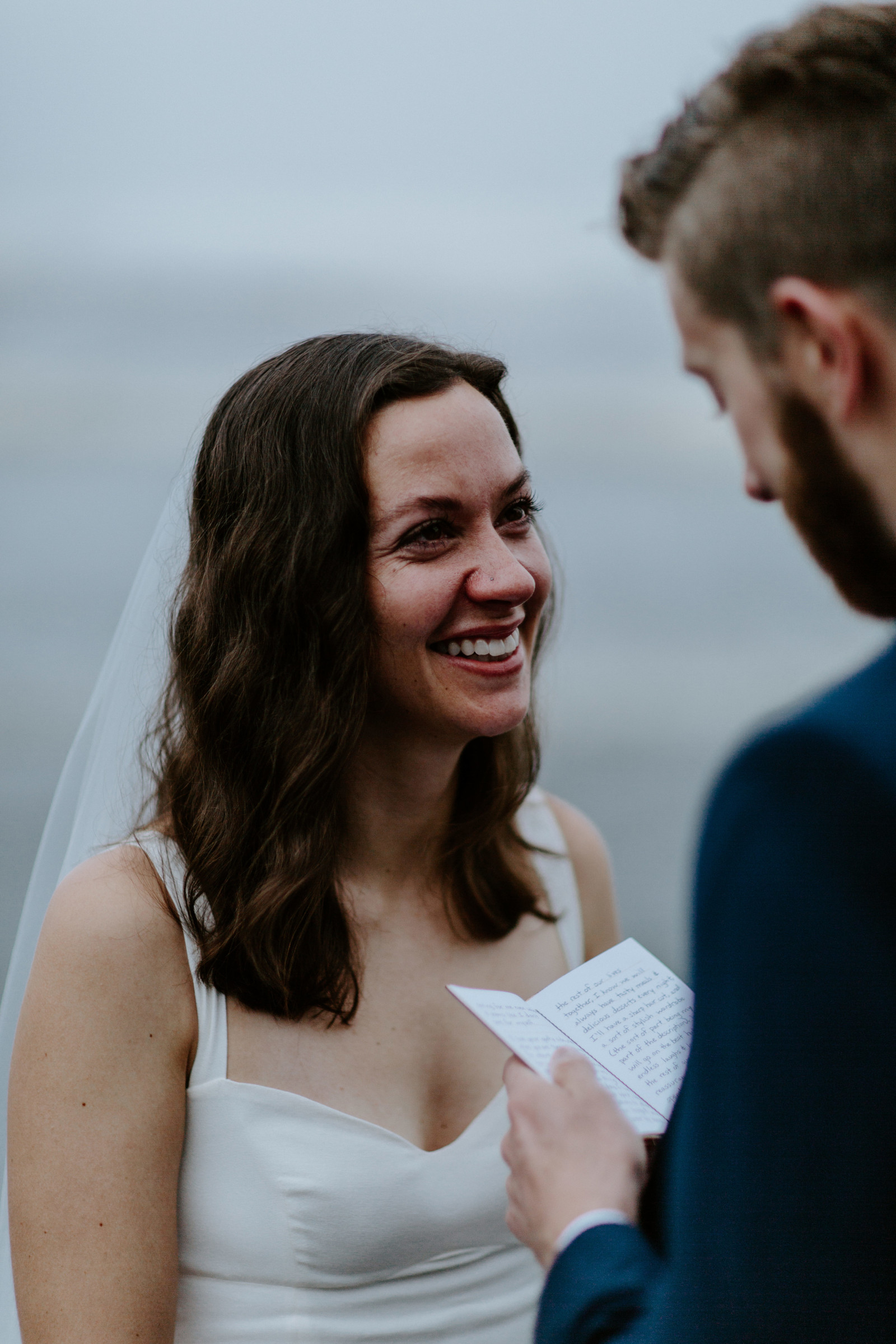 Mollie smiles at Corey as he reads his vows. Elopement photography in the Olympic National Park by Sienna Plus Josh.