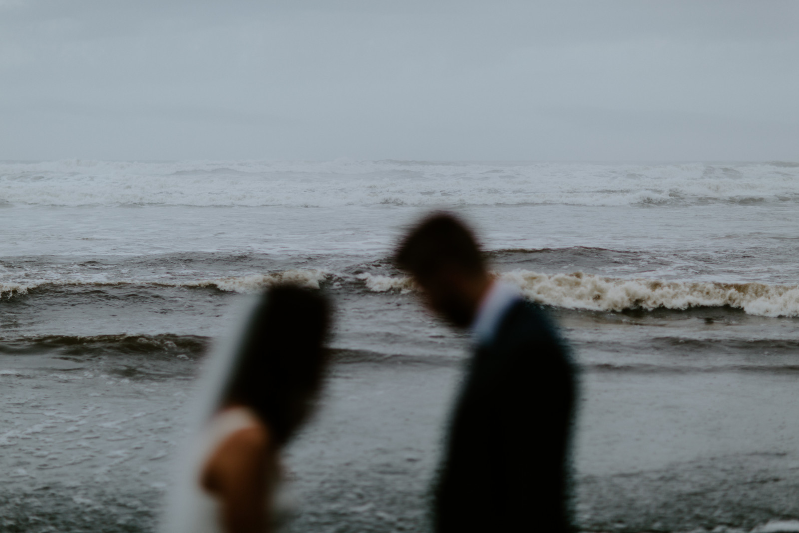 Mollie and Corey stand in front of the waves. Elopement photography at Olympic National Park by Sienna Plus Josh.