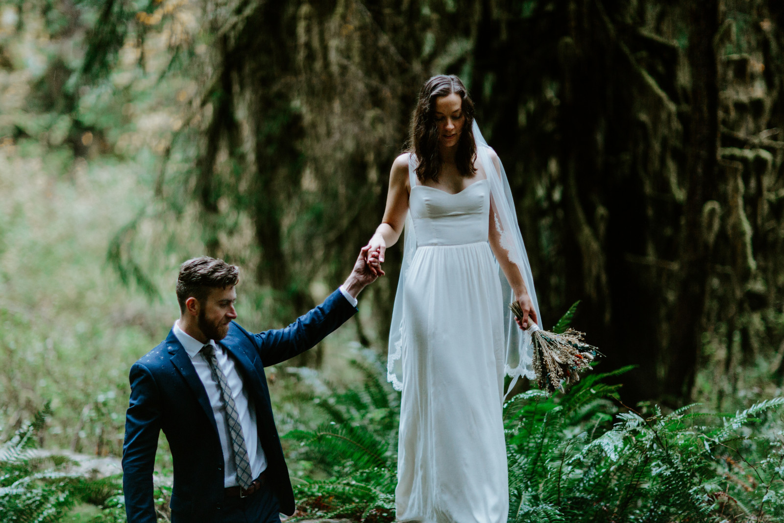 Mollie and Corey walk along a fallen tree. Elopement photography in the Olympic National Park by Sienna Plus Josh.
