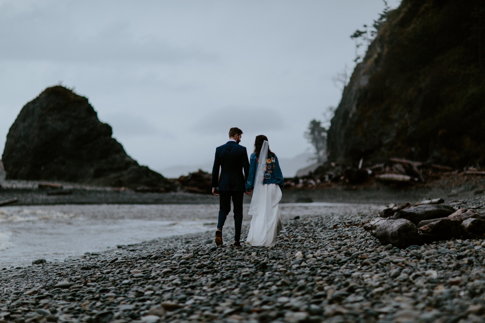 Corey and Mollie walk on the beach. Elopement photography at Olympic National Park by Sienna Plus Josh.