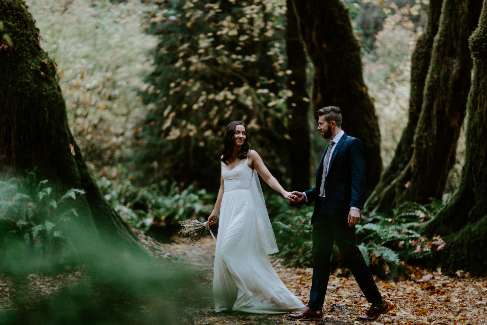 Corey and Mollie hold hands as they walk. Elopement photography in the Olympic National Park by Sienna Plus Josh.