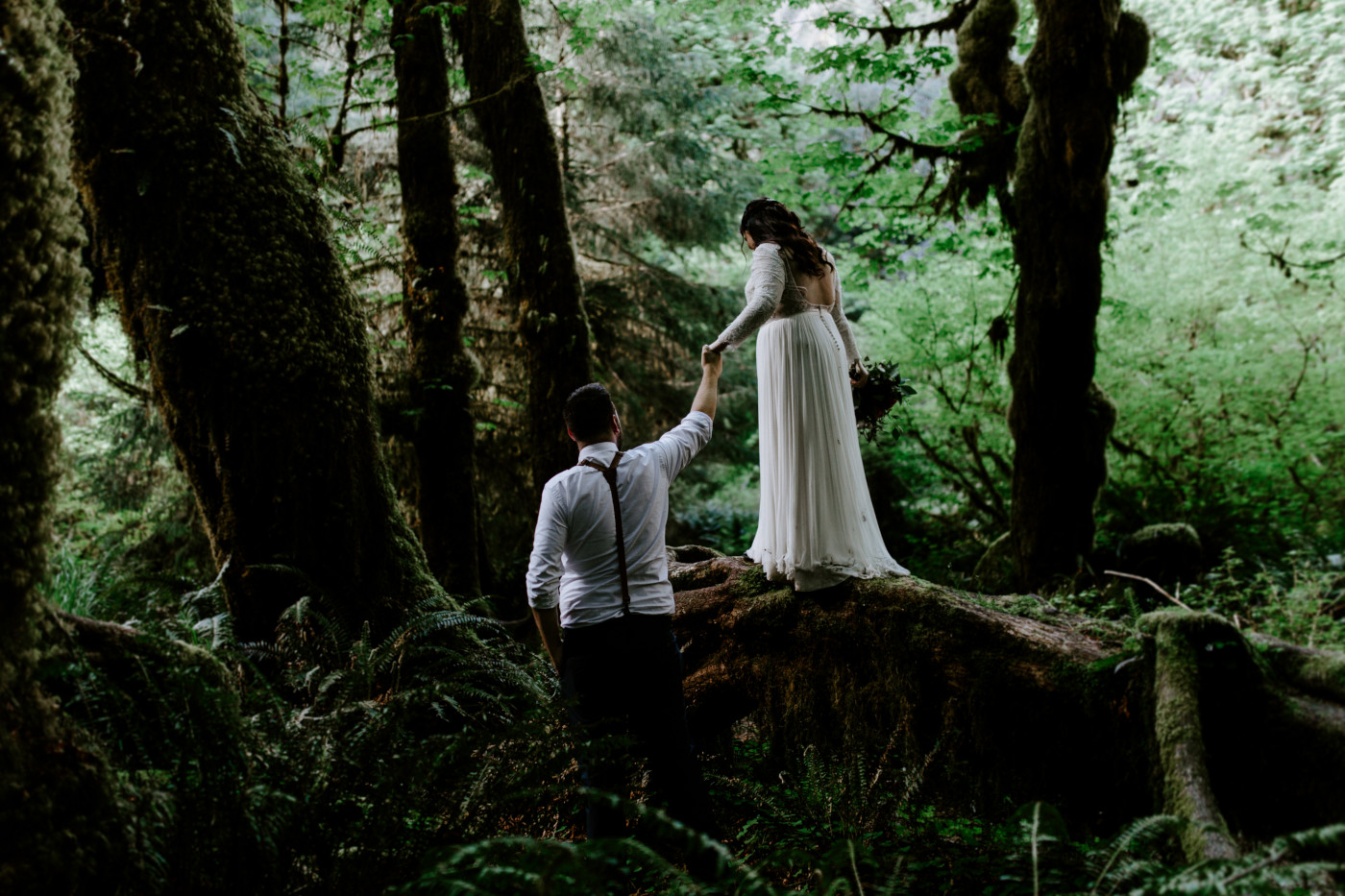 Jack helps Brooke walk across a log. Elopement photography at Olympic National Park by Sienna Plus Josh.