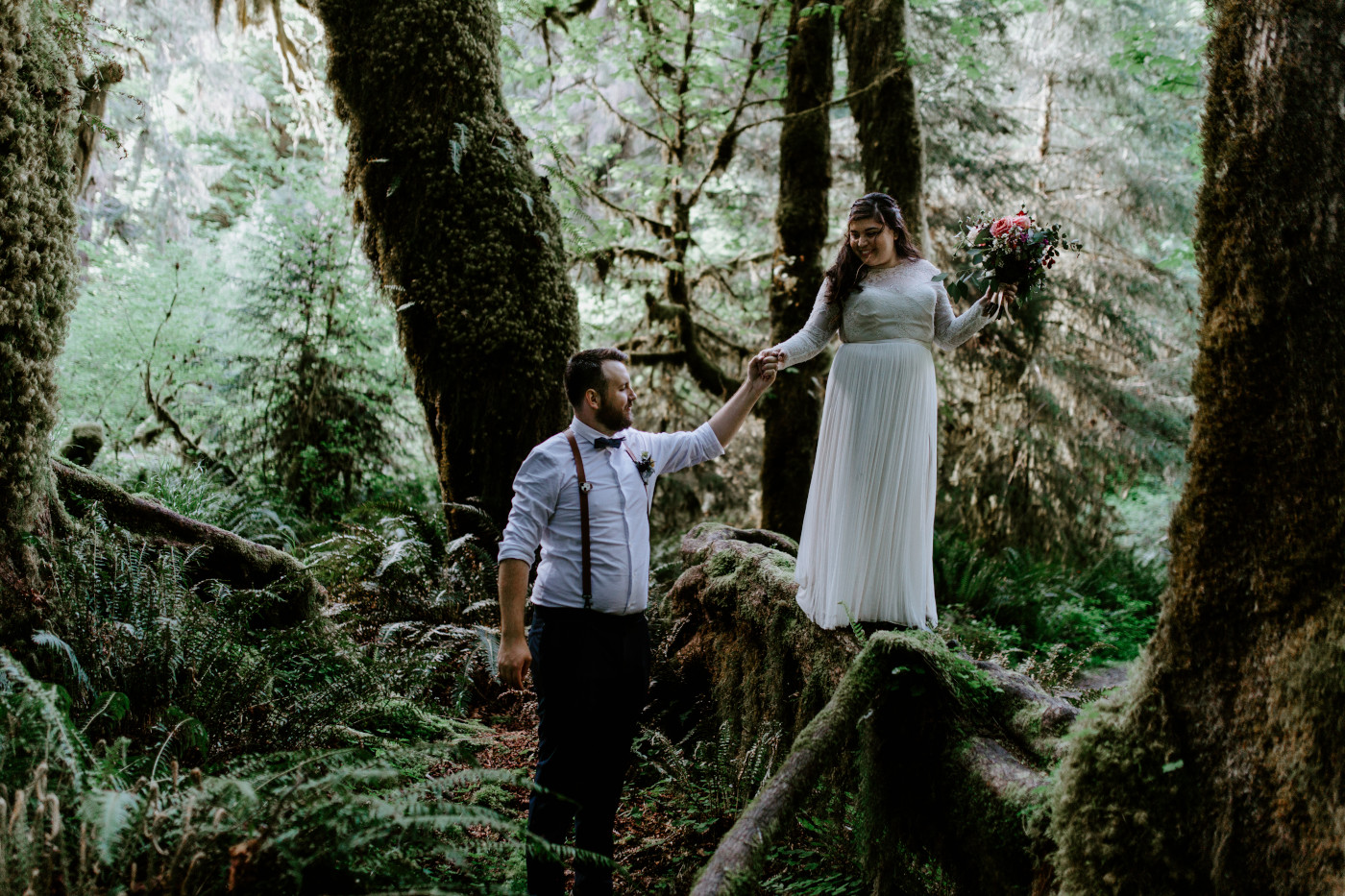 Brooke and Jack walking in the woods. Elopement photography at Olympic National Park by Sienna Plus Josh.