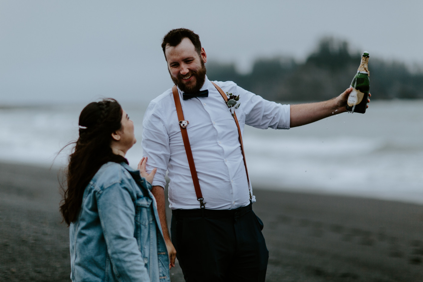 Brooke and Jack with the champagne bottle. Elopement photography at Olympic National Park by Sienna Plus Josh.
