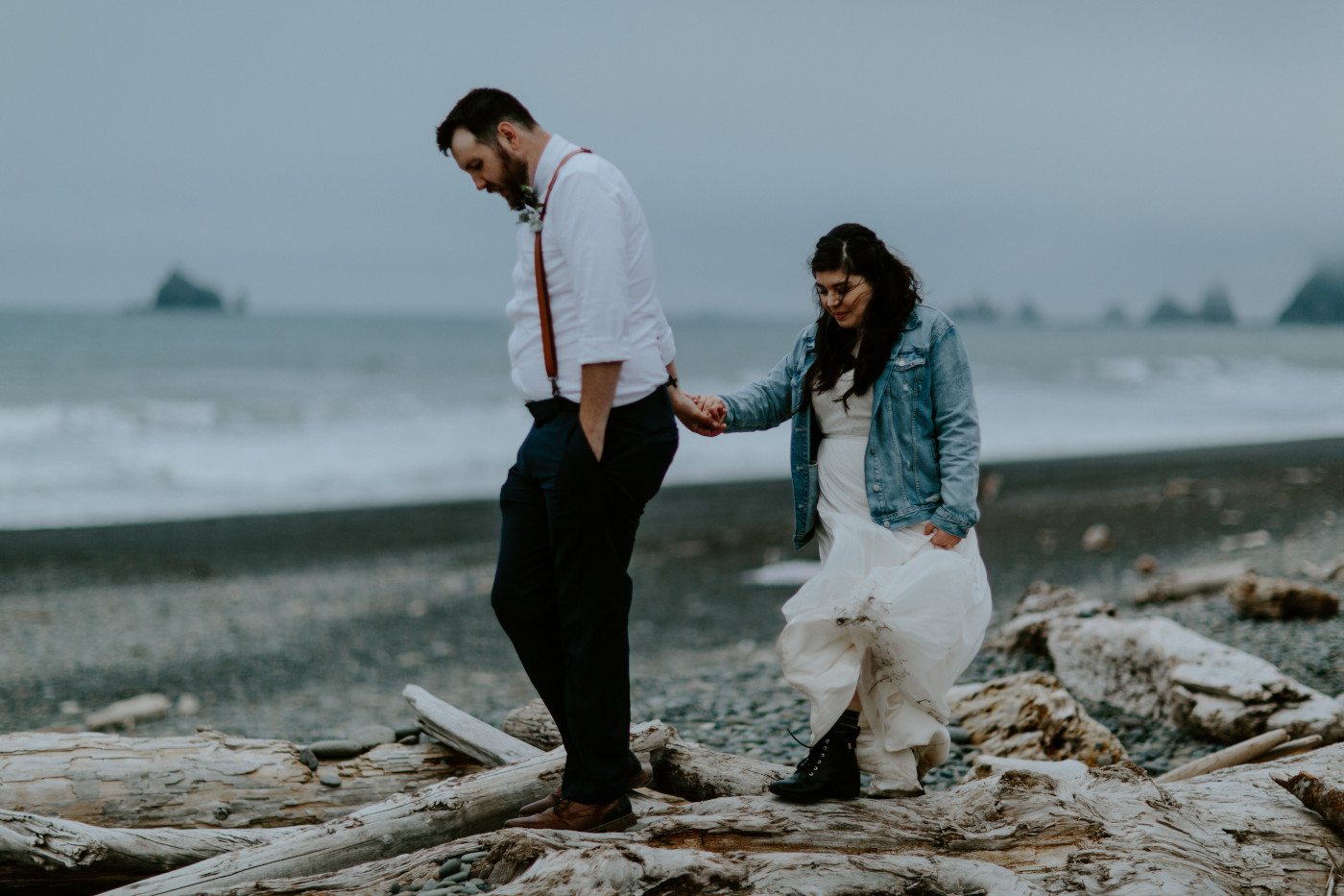 Jack and Brooke walk on the logs near the beach. Elopement photography at Olympic National Park by Sienna Plus Josh.