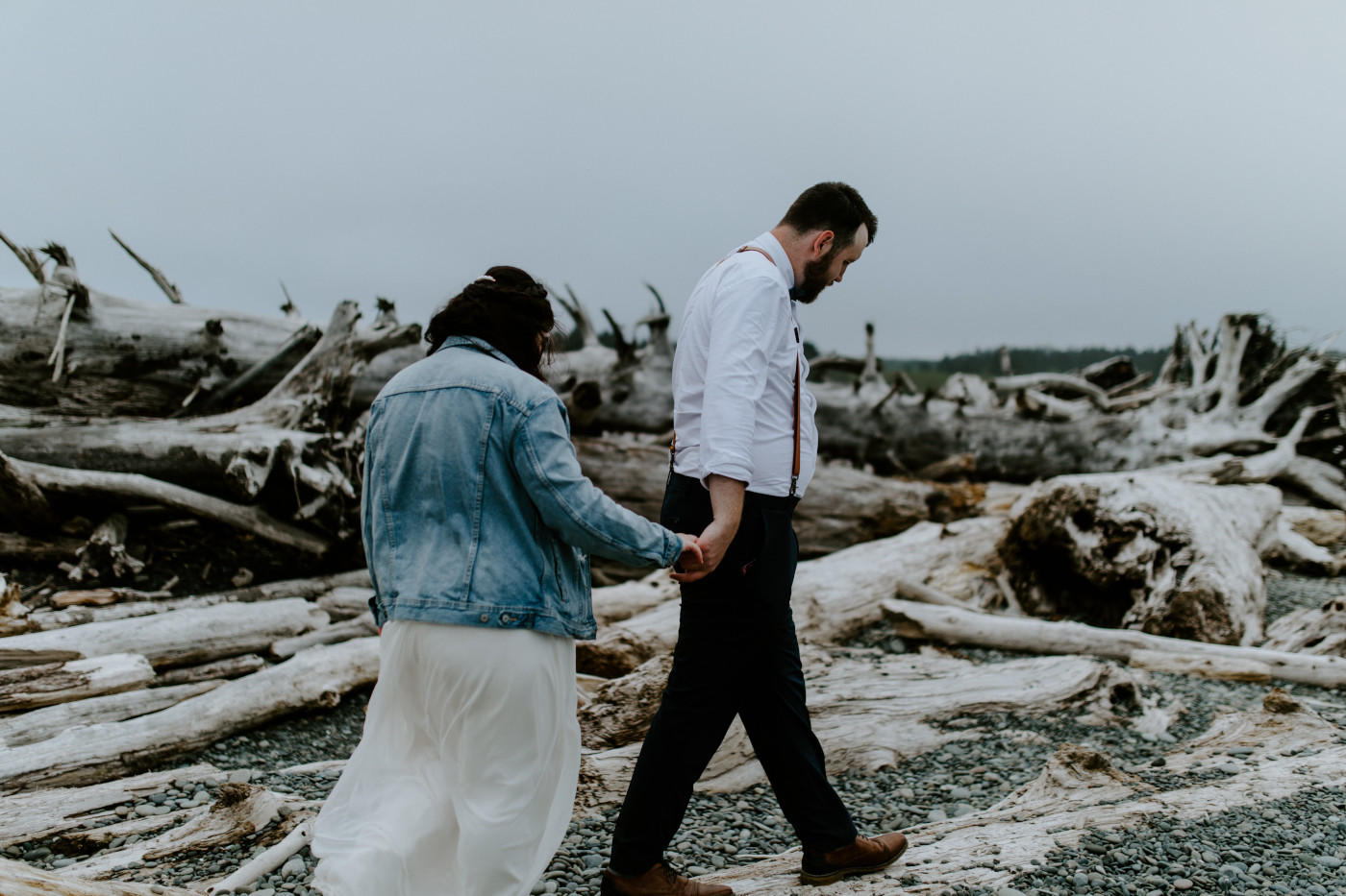 Brooke and Jack walk along a log. Elopement photography at Olympic National Park by Sienna Plus Josh.