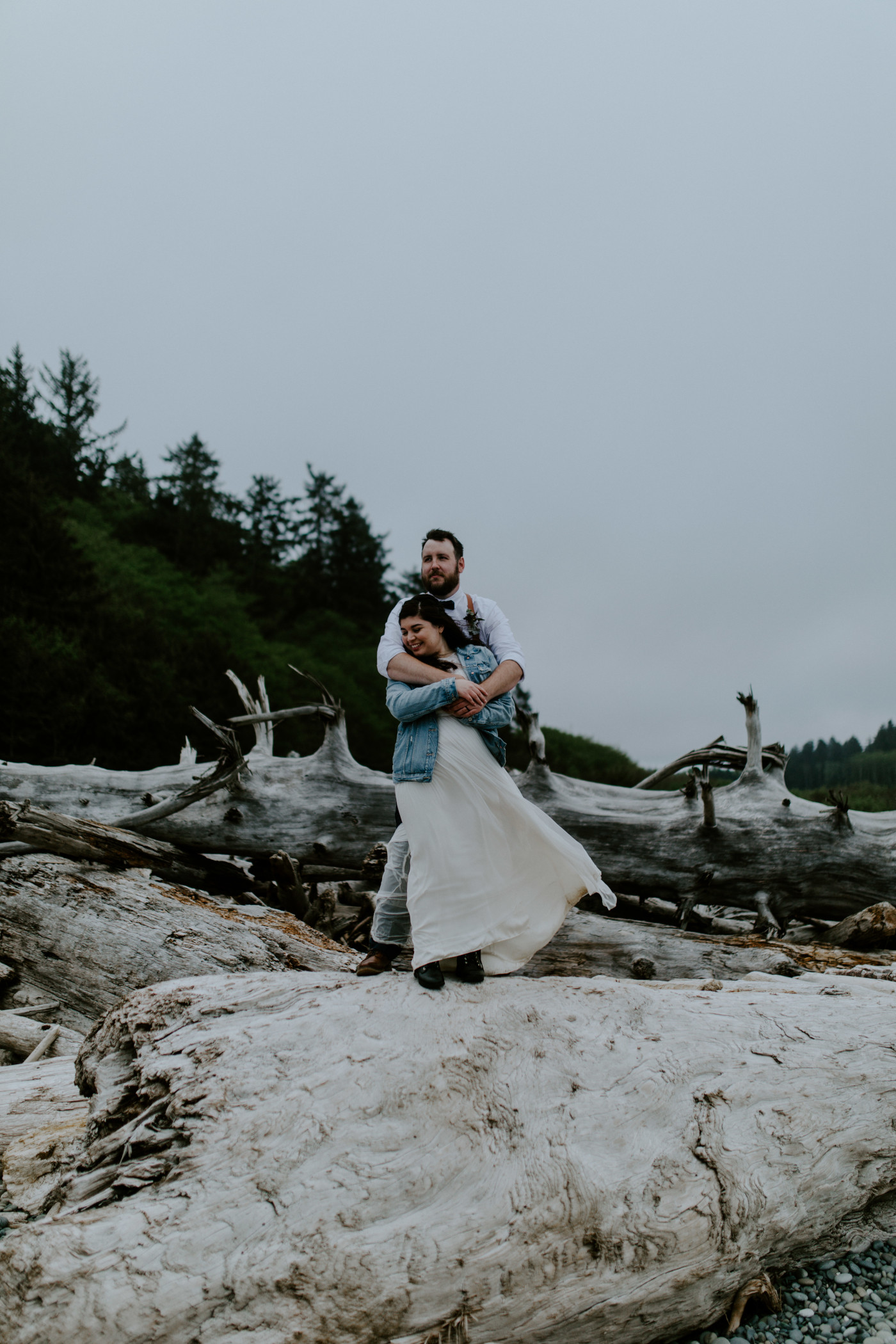 Brooke and Jack stand on a log. Elopement photography at Olympic National Park by Sienna Plus Josh.
