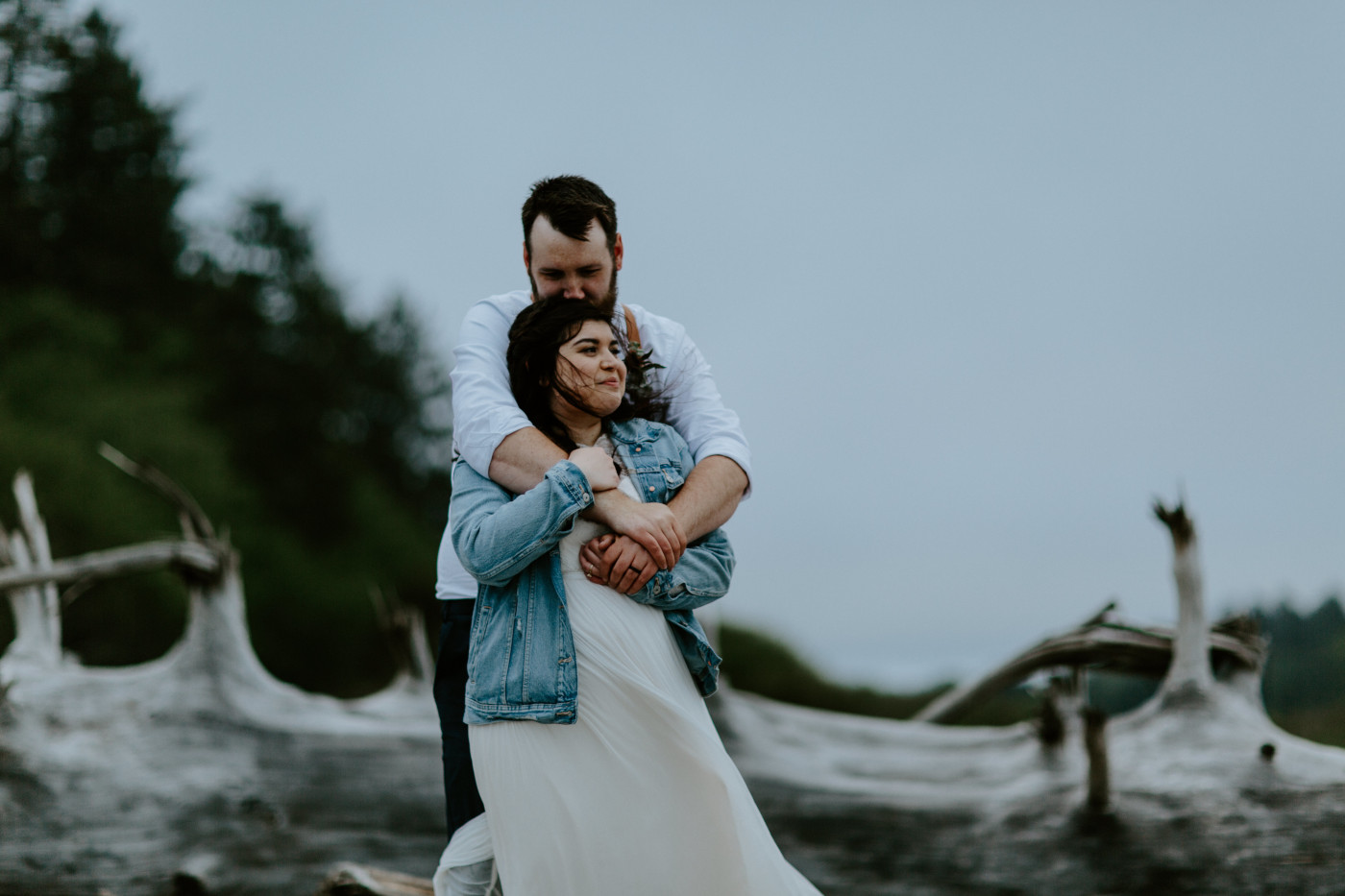 Brooke and Jack stand on the beach. Elopement photography at Olympic National Park by Sienna Plus Josh.