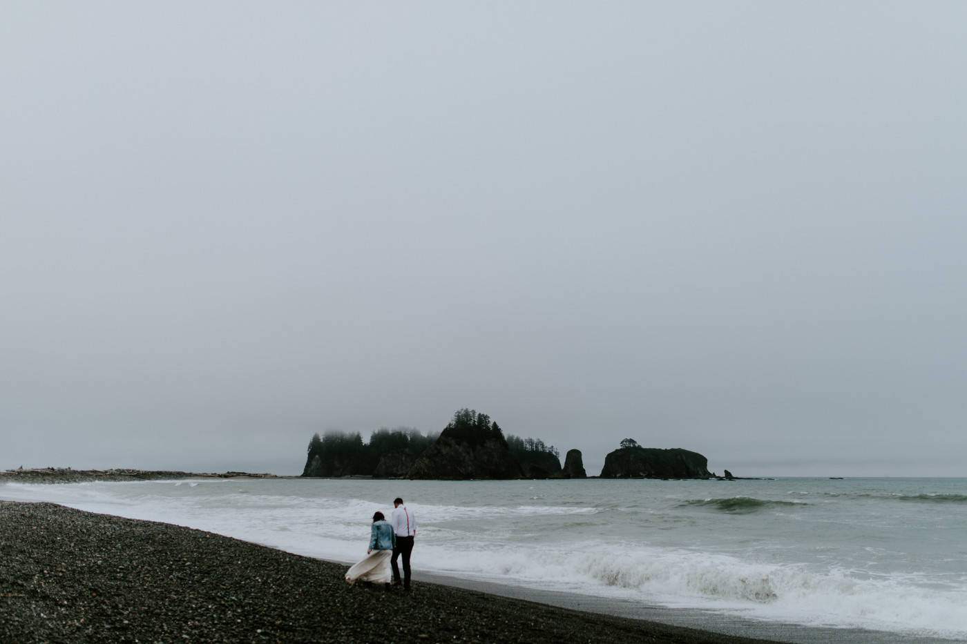 Brooke and Jack walk along the beach. Elopement photography at Olympic National Park by Sienna Plus Josh.