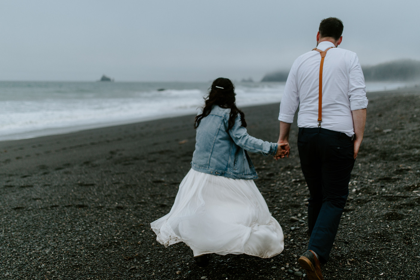 Brooke and Jack walking on Rialto beach. Elopement photography at Olympic National Park by Sienna Plus Josh.