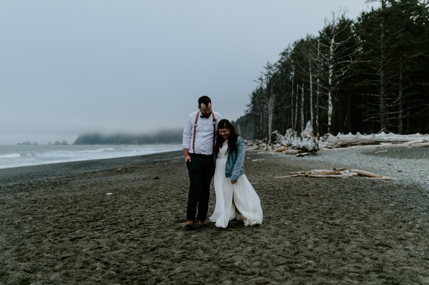 Brooke and Jack walking on the beach. Elopement photography at Olympic National Park by Sienna Plus Josh.